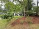 Exterior view of house with green lawn and mature trees at 3013 Barcelona Way, Conyers, GA 30012