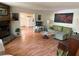 Inviting living room featuring a stone fireplace, and hardwood floors at 3013 Barcelona Way, Conyers, GA 30012