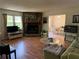 Cozy living room with stone fireplace, hardwood floors, and dining room view at 3013 Barcelona Way, Conyers, GA 30012