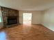 Spacious living room featuring hardwood floors and a stone fireplace at 3013 Barcelona Way, Conyers, GA 30012