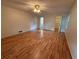 Hardwood floor main bedroom with a ceiling fan, large windows, and closet access at 3013 Barcelona Way, Conyers, GA 30012