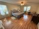 Cozy main bedroom with wood floors and natural light from two large windows at 3013 Barcelona Way, Conyers, GA 30012