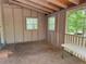 Inside view of the home's screened-in porch with a plywood floor and tongue-in-groove ceiling at 3013 Barcelona Way, Conyers, GA 30012