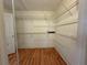 Walk-in closet with custom installed shelving and hardwood floors at 3013 Barcelona Way, Conyers, GA 30012