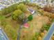 Aerial view of wooded property with house, barn, driveway, and surrounding houses at 1828 Kellogg Creek Rd, Acworth, GA 30102
