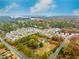 Expansive aerial view of a lakeside residential community surrounded by colorful fall foliage at 1828 Kellogg Creek Rd, Acworth, GA 30102