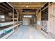 Barn interior with wooden beams and partially divided stalls and a metal roof at 1828 Kellogg Creek Rd, Acworth, GA 30102