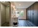 Bathroom featuring double vanity, black tile floor, shower, and dark storage at 1828 Kellogg Creek Rd, Acworth, GA 30102