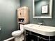 A modern half bathroom with a stylish sink, faucet, and wooden cabinet at 1828 Kellogg Creek Rd, Acworth, GA 30102