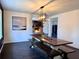 Dining room with a stone fireplace and hearth, a modern light fixture and a dark wood table at 1828 Kellogg Creek Rd, Acworth, GA 30102