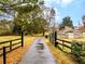 Long, gated driveway leading to a rustic outbuilding on a lush, green property at 1828 Kellogg Creek Rd, Acworth, GA 30102