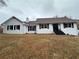 Charming one-story home with a white brick facade, black shutters, and covered front entry at 1828 Kellogg Creek Rd, Acworth, GA 30102