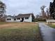 Well-maintained one-story brick home with a lush, green front lawn and side-entry garage at 1828 Kellogg Creek Rd, Acworth, GA 30102
