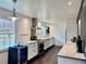 Bright kitchen features white cabinets, modern appliances, wine fridge, and an expansive view of the outdoors at 1828 Kellogg Creek Rd, Acworth, GA 30102