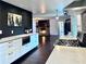 Open-concept kitchen featuring modern appliances, dark wood floors, and a stone fireplace in the adjacent living area at 1828 Kellogg Creek Rd, Acworth, GA 30102