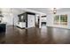Open-concept living area with hardwood floors, dark accent wall, and lots of natural light at 1828 Kellogg Creek Rd, Acworth, GA 30102