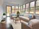 Staged sunroom with abundant natural light, modern furniture, and views of the backyard at 1828 Kellogg Creek Rd, Acworth, GA 30102