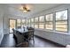 Bright sunroom with large windows, a dining table, and views of the backyard at 1828 Kellogg Creek Rd, Acworth, GA 30102