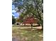 A lush green lawn with mature trees and a small wooden structure in the distance at 1828 Kellogg Creek Rd, Acworth, GA 30102