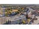 An aerial view of neighborhood buildings and a lovely town green, surrounded by beautiful trees with fall colors at 2210 Hamstead Ct, Suwanee, GA 30024