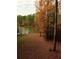Scenic backyard view with lake access and mature trees showing fall colors at 2210 Hamstead Ct, Suwanee, GA 30024