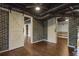 Finished basement with exposed ductwork, barn doors, and brick accent wall at 2210 Hamstead Ct, Suwanee, GA 30024