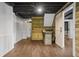 Finished basement features wood-look floors, ceiling fan, and rustic bar area with sliding barn door at 2210 Hamstead Ct, Suwanee, GA 30024