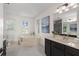 Bathroom features soaking tub, single vanity with dark cabinets, and toilet at 2210 Hamstead Ct, Suwanee, GA 30024