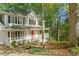Beautiful two-story home with a bright red front door, classic shutters, and a meticulously landscaped yard at 2210 Hamstead Ct, Suwanee, GA 30024