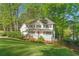 Charming two-story home with a welcoming front porch and beautifully landscaped front yard, surrounded by mature trees at 2210 Hamstead Ct, Suwanee, GA 30024