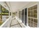 Inviting front porch with classic white railings and ample natural light streaming through large windows at 2210 Hamstead Ct, Suwanee, GA 30024