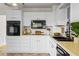 Classic kitchen boasts white cabinets, black appliances, and a clean, functional design at 2210 Hamstead Ct, Suwanee, GA 30024