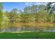 Serene lake view with lush green grass and bench seating, offering a peaceful and scenic environment at 2210 Hamstead Ct, Suwanee, GA 30024