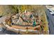 A large community playground for children, featuring wood structures, swings, and slides, next to a parking area at 2210 Hamstead Ct, Suwanee, GA 30024