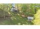 Picturesque property showcasing a lush lawn, charming greenhouse, and a well-maintained home among the trees at 2210 Hamstead Ct, Suwanee, GA 30024