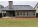 Back exterior view of the home featuring a covered patio and large backyard at 3622 Foxtrot Nw Trl, Kennesaw, GA 30144