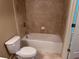 Bathroom with a white tub and beige tiled walls at 3622 Foxtrot Nw Trl, Kennesaw, GA 30144