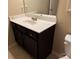 Single sink bathroom vanity with white countertop, dark cabinetry, and neutral paint at 3622 Foxtrot Nw Trl, Kennesaw, GA 30144