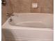 Close up on a white bathtub with tiled walls at 3622 Foxtrot Nw Trl, Kennesaw, GA 30144
