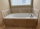 Bathroom showcasing a large soaking tub with tile surround, and tiled floors at 3622 Foxtrot Nw Trl, Kennesaw, GA 30144