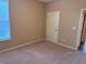 Neutral painted bedroom with carpet flooring, one window, and a white door at 3622 Foxtrot Nw Trl, Kennesaw, GA 30144