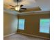 Large carpeted bedroom with tray ceiling, ceiling fan and two windows with neutral paint at 3622 Foxtrot Nw Trl, Kennesaw, GA 30144
