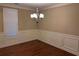 Dining room with hardwood floors, wainscoting, and modern chandelier at 3622 Foxtrot Nw Trl, Kennesaw, GA 30144
