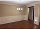 Dining room with hardwood floors, wainscoting, and modern chandelier at 3622 Foxtrot Nw Trl, Kennesaw, GA 30144