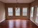 Dining room with hardwood floors, chandelier, three windows, and a door at 3622 Foxtrot Nw Trl, Kennesaw, GA 30144