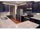 Bright kitchen showcasing granite counters, stainless steel appliances, and dark brown cabinetry at 3622 Foxtrot Nw Trl, Kennesaw, GA 30144