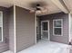 Relaxing covered patio with a ceiling fan, stylish brown siding, and an exterior door at 3622 Foxtrot Nw Trl, Kennesaw, GA 30144