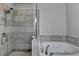 Elegant bathroom featuring a glass shower door, a rain shower head, and a separate tub at 4007 Dunwoody Trce, Atlanta, GA 30338