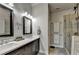Bathroom with double vanity, wood look tile, and a glass enclosed shower at 4007 Dunwoody Trce, Atlanta, GA 30338