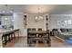 Open-concept dining room with hardwood floors, built-in shelving, and adjacent to a modern kitchen at 4007 Dunwoody Trce, Atlanta, GA 30338